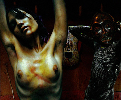 The JAL plane was downed by heat seeking missiles over a remote part of central Africa. Unfortunately for the only survivor she was taken by villagers deep in the forest. Taken to the sacrificial hut, she hears the priest that will conduct her ritual torture chant and adjust his mask.